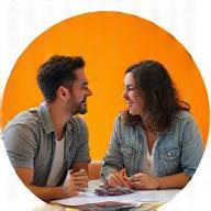 Image of two people sitting and discussing travel plans with enthusiasm.